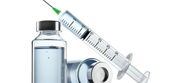 Two vials of vaccine and a syringe to administer the vaccine